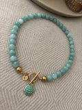 Ketting groen/turqoise met bedel schelp